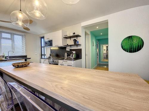 a kitchen with a large wooden counter top at Sunkissed - Brand New Beach apartment located 50m from beach in Flic-en-Flac