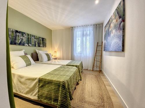a bedroom with two beds and a ladder in it at Sunkissed - Brand New Beach apartment located 50m from beach in Flic-en-Flac