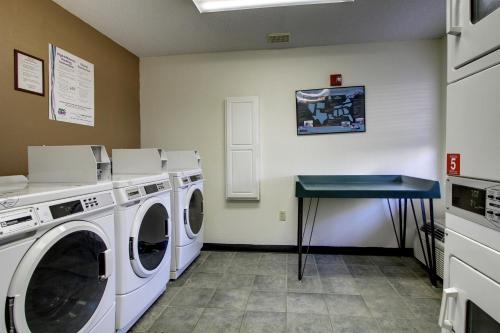 a laundry room with a washing machine and a table at InTown Suites Extended Stay Birmingham AL - Lakeshore Parkway in Birmingham