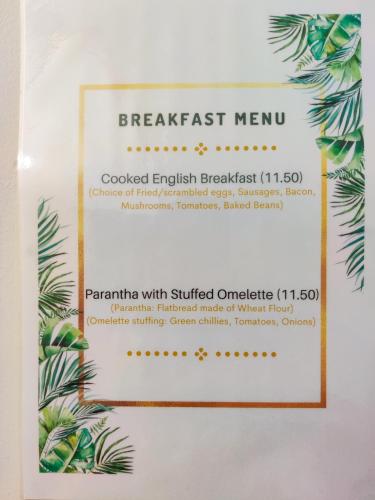a sign for a breakfast menu on a wall at Wentworth House - Free Parking in Bath