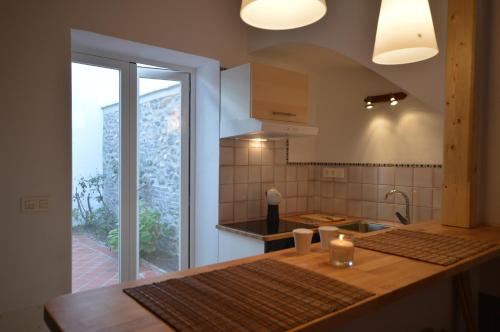 a kitchen with a counter with a sink and a window at Carmen de las Campanas in Granada