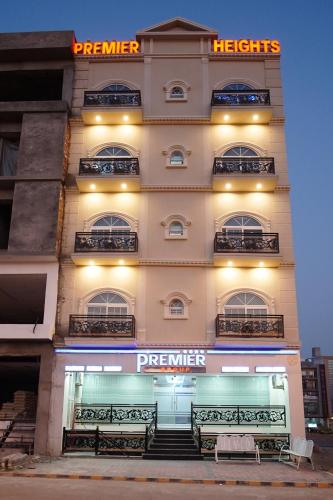 a building with benches in front of it at night at Premier Heights Jhelum in Jhelum