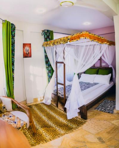 a bedroom with a bed with a canopy at Kilimanjaro Scenic Homestay in Moshi