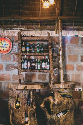 a bar with bottles on top of a brick wall at Kilimanjaro Scenic Homestay in Moshi