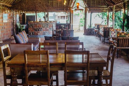 a dining room with a wooden table and chairs at Kilimanjaro Scenic Homestay in Moshi