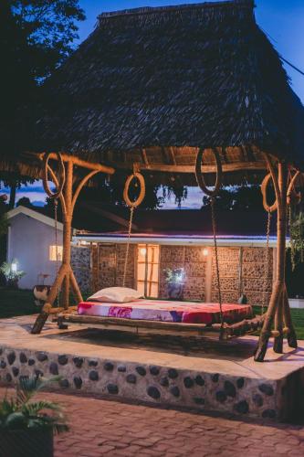 a bed in a gazebo at night at Kilimanjaro Scenic Homestay in Moshi