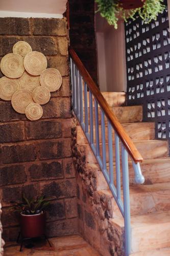a staircase with a bunch of hats on a wall at Kilimanjaro Scenic Homestay in Moshi