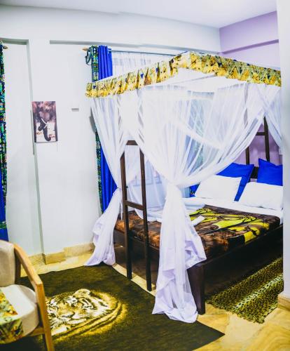 a bedroom with a bunk bed with a canopy at Kilimanjaro Scenic Homestay in Moshi