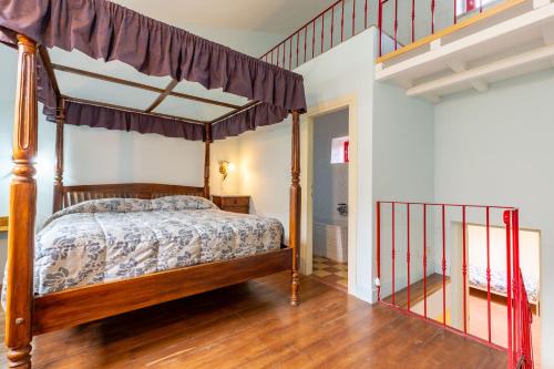 a bedroom with a canopy bed and a staircase at Casa Palmira - La Casina in Polcanto