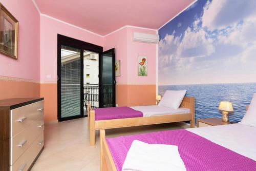 twee bedden in een kamer met uitzicht op de oceaan bij Apartments Coral in Kotor