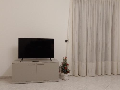 einen Flachbild-TV auf einer Kommode im Wohnzimmer in der Unterkunft Casa Lory in Colico
