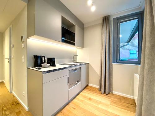 a kitchen with a counter and a window at Blackhome Wien I contactless check-in in Vienna