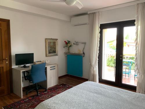 a bedroom with a bed and a desk and a television at B&B Il Ciliegio in Lomnago