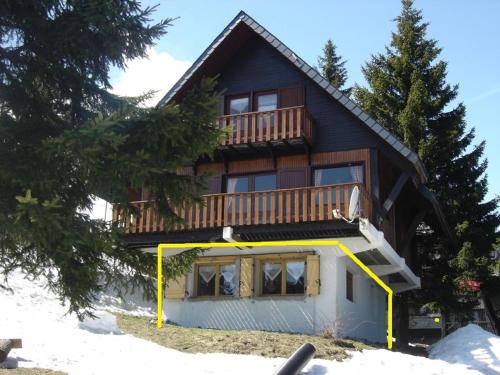 a house with a deck on the side of it at Appartement au pied des pistes in Saint-Lary-Soulan