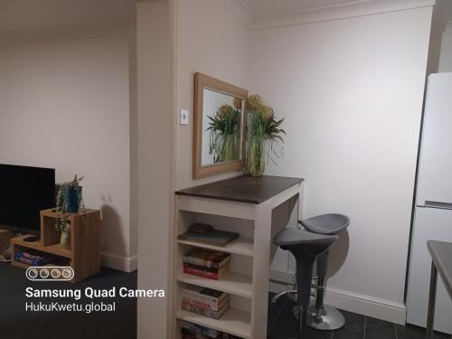 a room with a desk with a mirror and a stool at Huku Kwetu -The Maltings- Black Door-1st Floor-2 Bedroom Apartment -Self Catering-Quiet- Free Parking in Dunstable