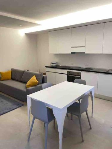 ein Wohnzimmer mit einem weißen Tisch und einem Sofa in der Unterkunft Sweet home... Parking inside in Azzano San Paolo