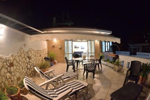 a patio with chairs and a table on a patio at Casa Capolino in Scauri