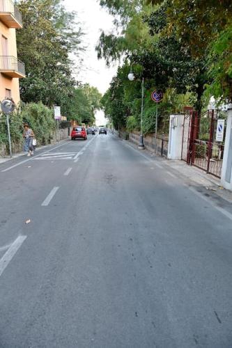 an empty street with cars driving down the road at Casa Capolino in Scauri