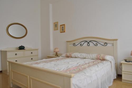 a bedroom with a large bed and a mirror at Lombardi Abbeveratoia in Parma