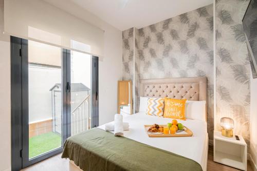 a bedroom with a bed with a tray of fruit on it at Global Home-Pico Cebollera in Madrid