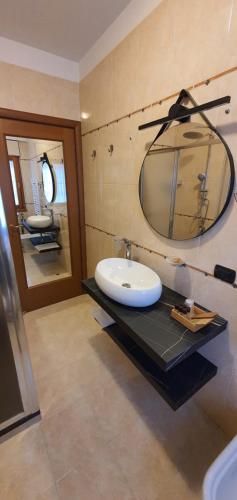 a bathroom with a sink and a mirror at Home-like Apartment in Rome