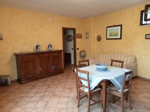 a living room with a table and chairs and a couch at Country-House vista montagna in Foce