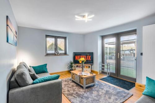 a living room with a couch and a table at Isabel's wing! A stunning 2 bedroom Property in Norwich