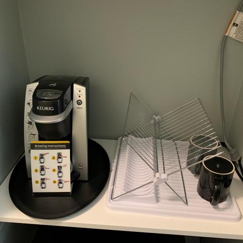 a counter with a coffee maker and a blender on it at Windtower Lodge - Canmore in Canmore