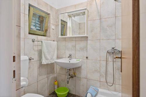 y baño con lavabo, aseo y ducha. en House Mirta en Pašman