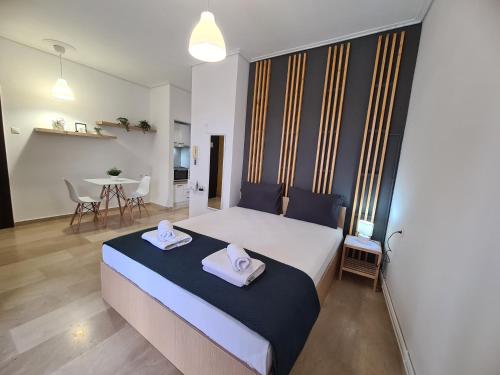 a bedroom with a large bed with two towels on it at Apartment in the heart of the city 5Β in Larisa