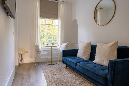a blue couch in a living room with a window at No 2 at Albion Terrace in Bath