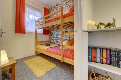 a bedroom with two bunk beds in a room at Hagrid's Hut in Watford