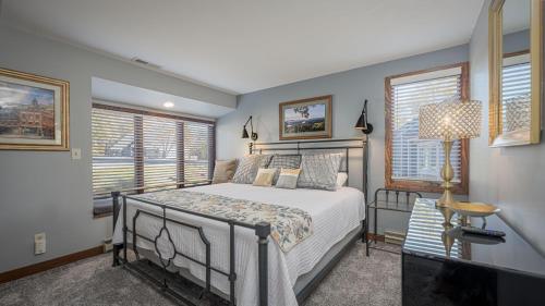 a bedroom with a bed and two windows at Three Kings and A Little Bling in Galena