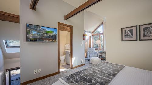 a bedroom with a bed and a hallway with a chair at Three Kings and A Little Bling in Galena