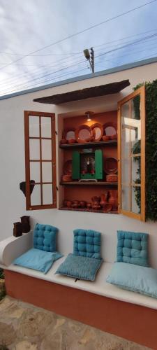 a room with two blue chairs sitting on a house at Casa Odélia in Almargem do Bispo