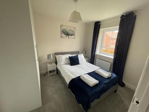 um quarto com uma cama com duas almofadas e uma janela em 6 bedroom Astan House in Beeston Nottingham em Nottingham