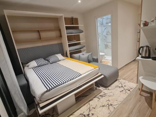 a bedroom with a bed and a bunk bed at Studio 2022 terrasse parking 5 min d'Annecy in Poisy