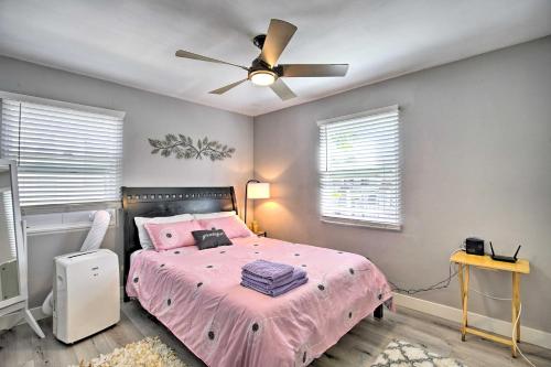 a bedroom with a pink bed with a ceiling fan at Contemporary 2 BR House w/ Yard, near Balboa & Downtown in National City