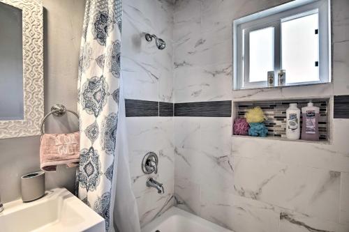a white bathroom with a shower and a sink at Contemporary 2 BR House w/ Yard, near Balboa & Downtown in National City