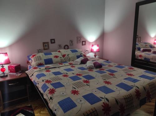 a bedroom with a bed with a quilt on it at Branka in Surčin