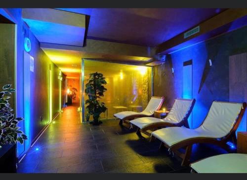 a room with chairs and a room with blue lights at Olimpic Village TH Sestriere apartments in Sestriere