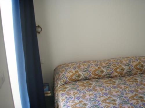 a bed sitting in a room with a couch at Bivani sul porto vecchio in Lampedusa