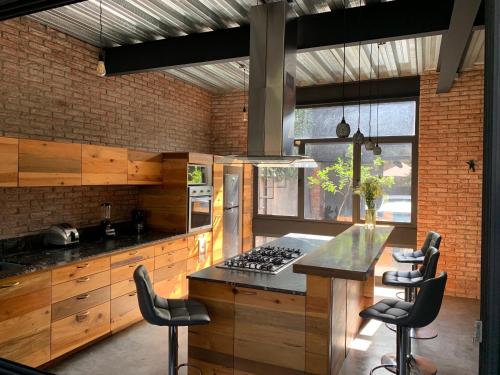 a kitchen with wooden cabinets and a table with chairs at Mi Refugio San Angel in Mexico City