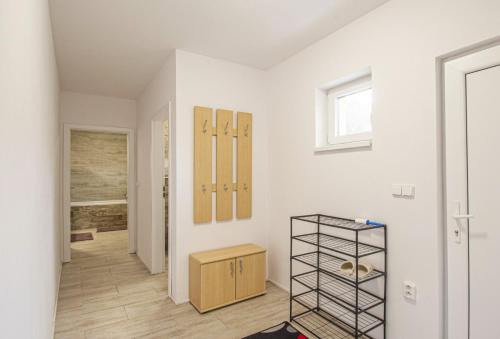 a white room with a closet and a shelf at Velký apartmán Zlámanka in Kroměříž