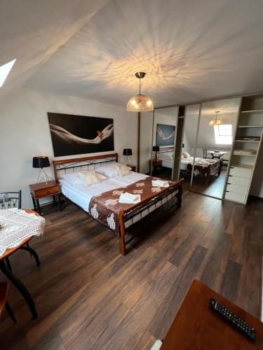 a bedroom with a bed in a room with wooden floors at Apartament Pieniny Dream in Krościenko