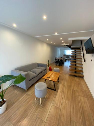 a living room with a couch and a table at ROMA apartamento frente al mar in Mar del Plata