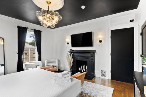 a bedroom with a white bed and a fireplace at The Coach House in Salem