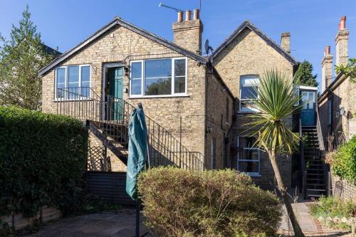 a brick house with a staircase in front of it at The Apartment on Granville in Sevenoaks