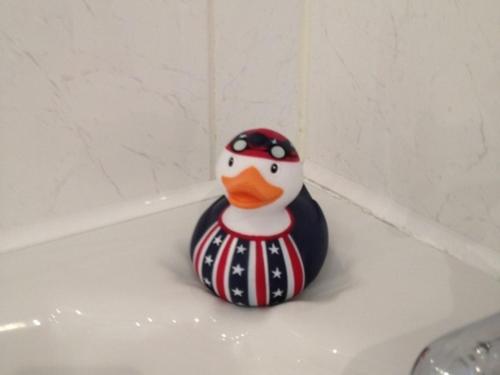 a toy rubber duck sitting on top of a bath tub at The Apartment on Granville in Sevenoaks