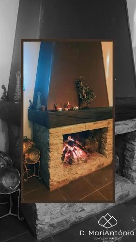 a fire place in a room with a fireplace at D. MariAntónia Complexo Turístico in Bragança